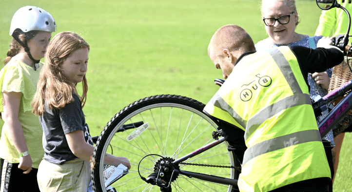 A young man fixing a bike
